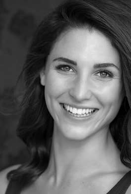fifthavenuesmile | Black and white photo of a woman with shoulder-length hair smiling broadly and showing teeth
